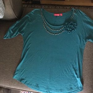 Turquoise Elle top with rivet & flower detailing.